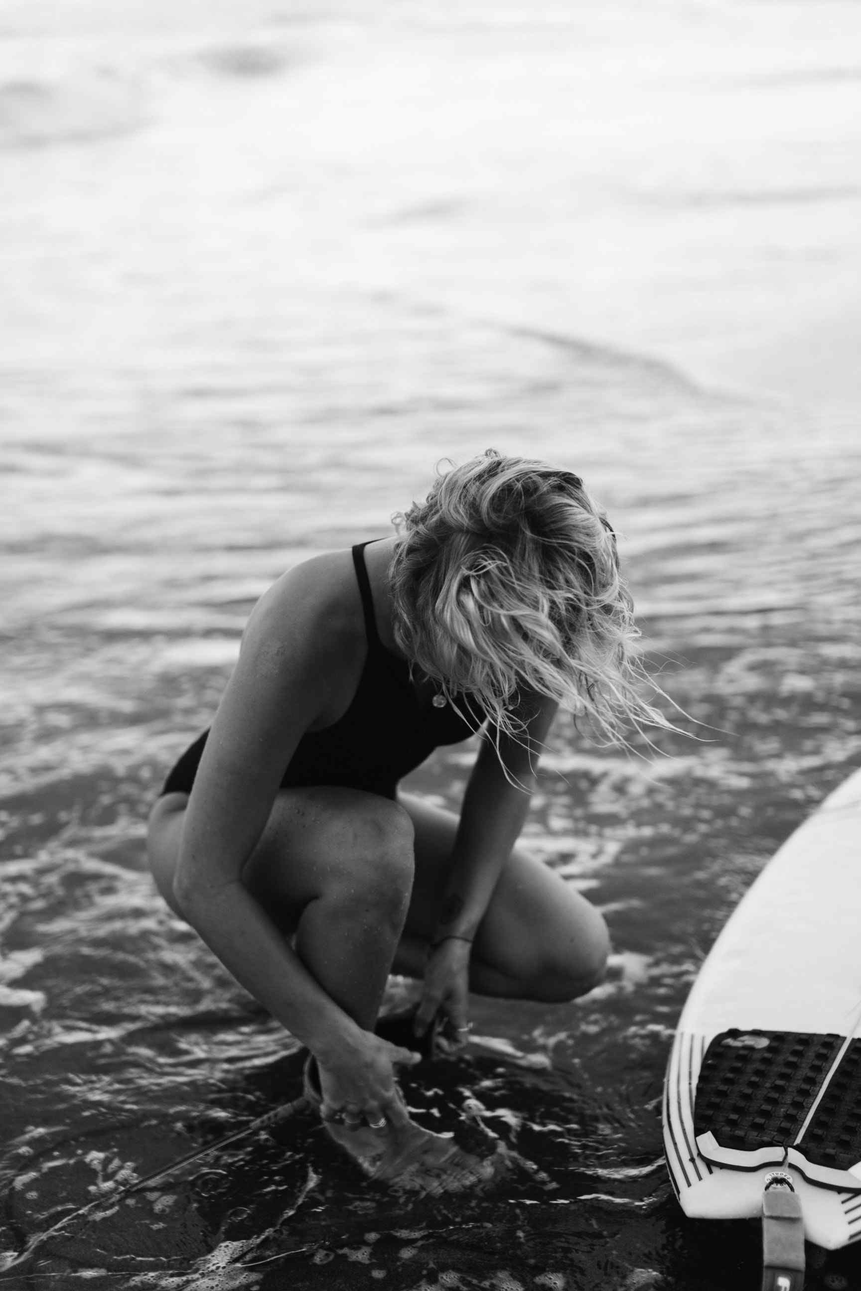 Girl on beach with surf board